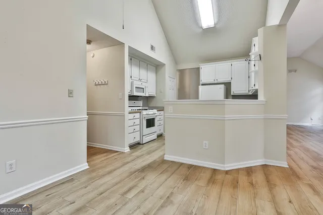 a kitchen with stainless steel appliances a refrigerator and a stove top oven