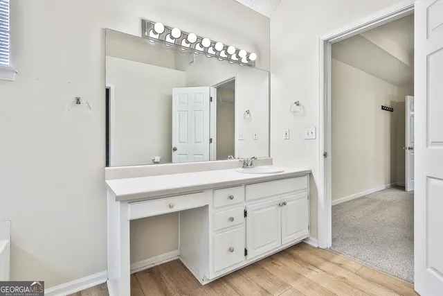 a bathroom with a double vanity sink and a mirror