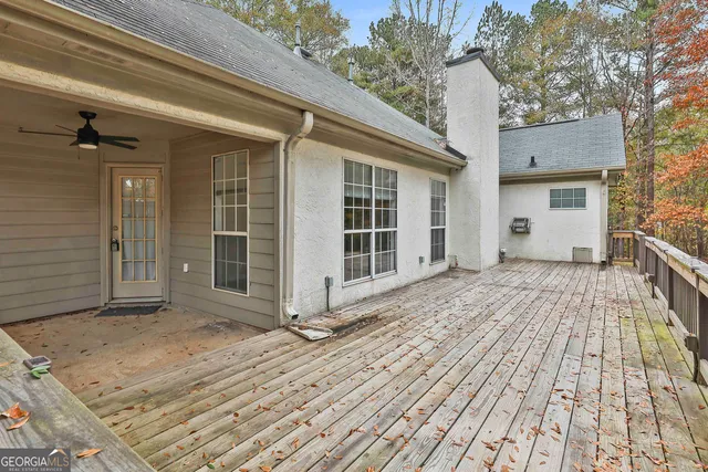 a view of a house with a wooden deck