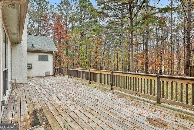 a balcony with wooden floor and fence