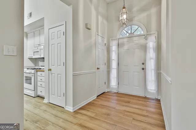 a view of a hallway with wooden floor