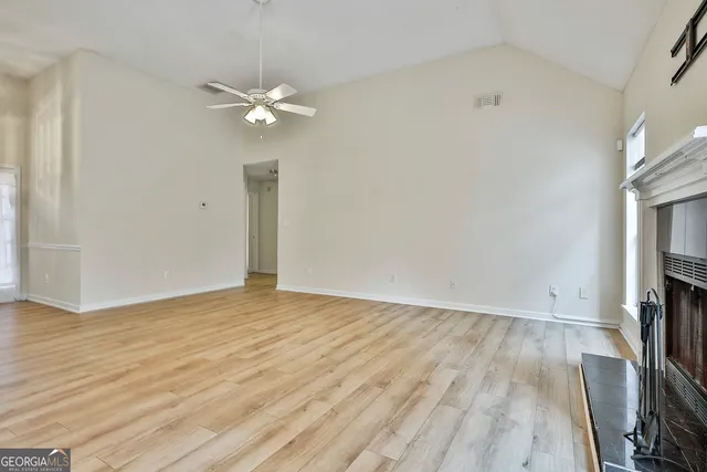 wooden floor in an empty room with a fireplace