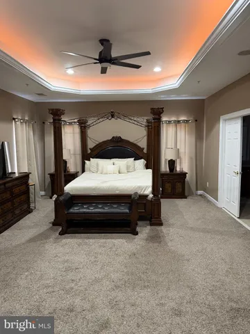 a bedroom with a bed and a car parked