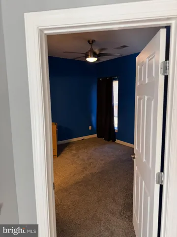 a view of a hallway with wooden shelves