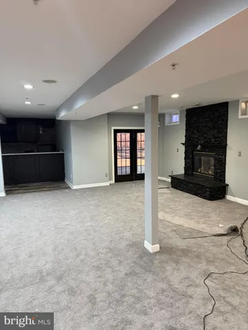 a kitchen with kitchen island granite countertop a sink a counter top space and cabinets