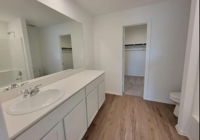 a spacious bathroom with a sink and a mirror