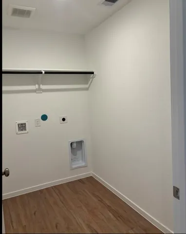 a view of a small space with wooden floor