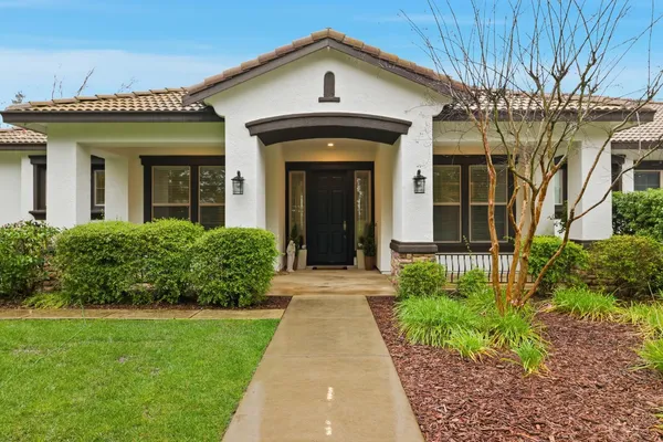 a front view of a house with a yard