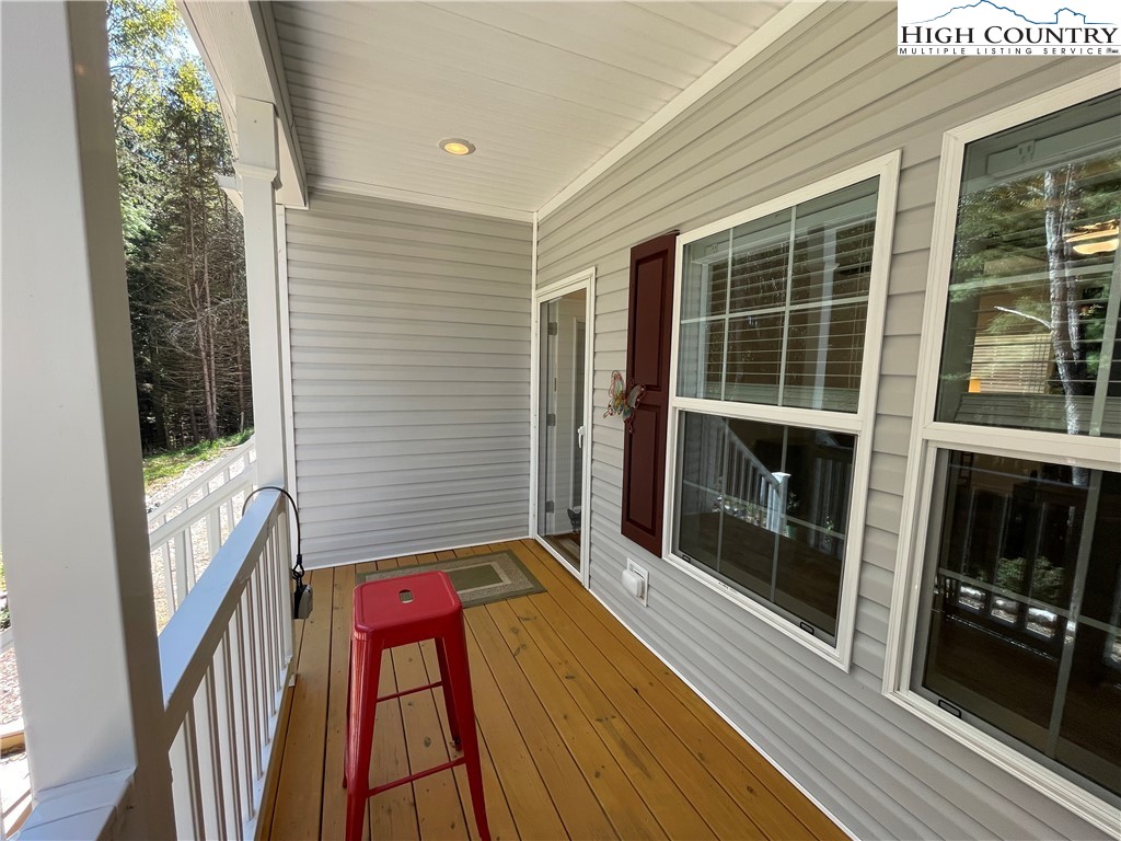 227 Meadow Pines Trail Boone, NC 28607 - Photo 11 of 34 a view of a balcony with wooden floor and staircase