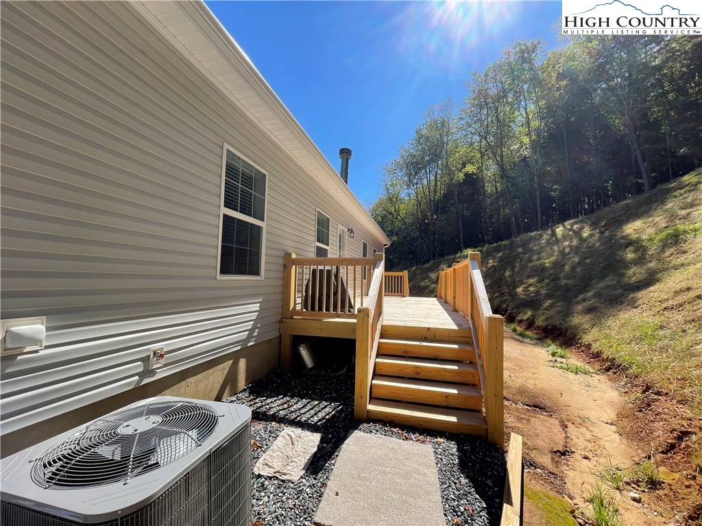 227 Meadow Pines Trail Boone, NC 28607 - Photo 13 of 34 a view of a patio with two chairs and a flower pot
