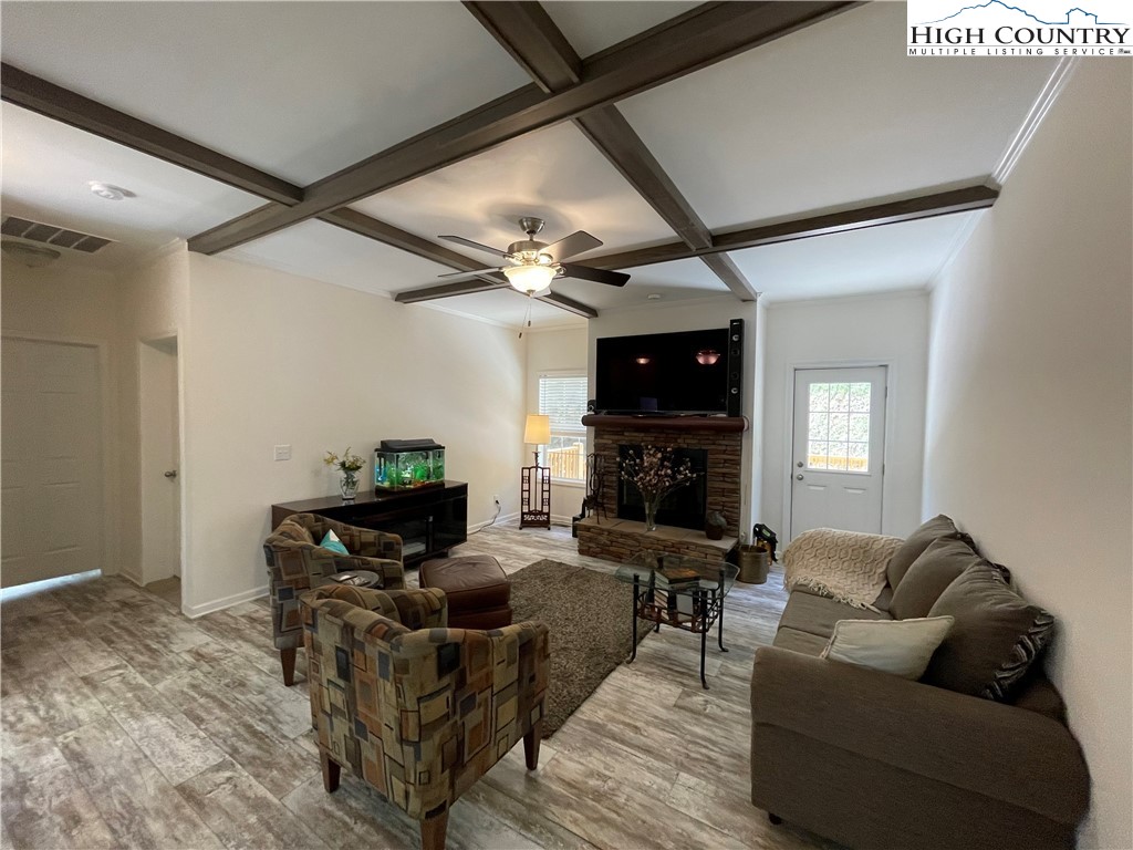 227 Meadow Pines Trail Boone, NC 28607 - Photo 17 of 34 a living room with furniture a fireplace and a flat screen tv