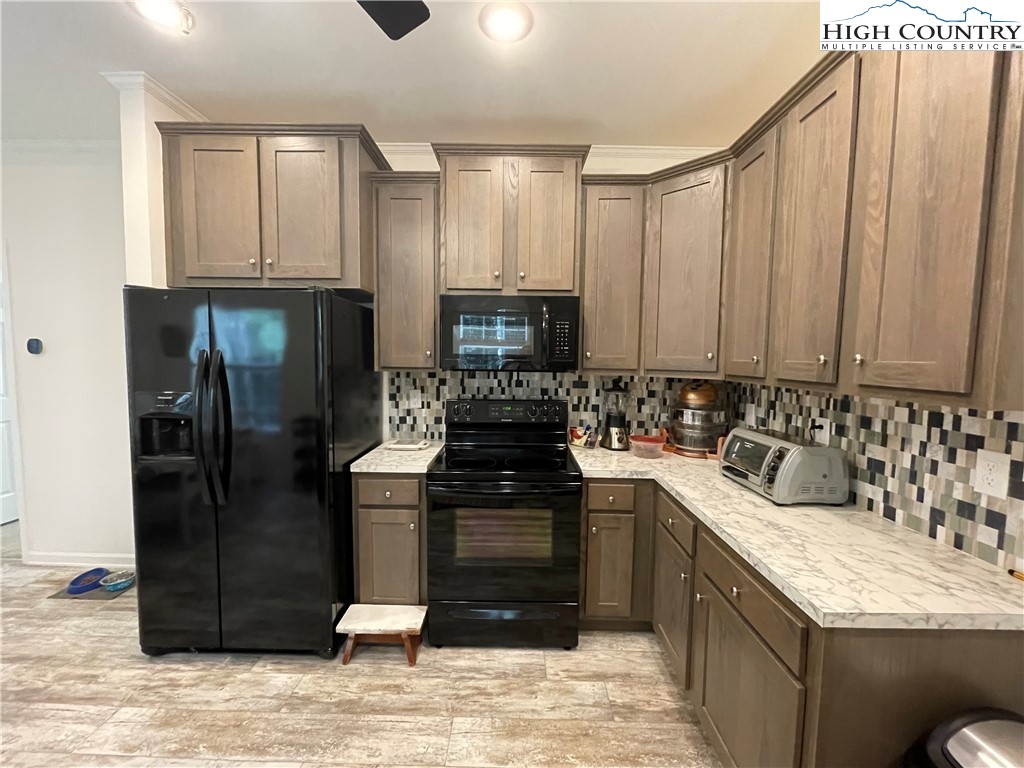 227 Meadow Pines Trail Boone, NC 28607 - Photo 23 of 34 a kitchen with stainless steel appliances granite countertop a refrigerator stove and sink