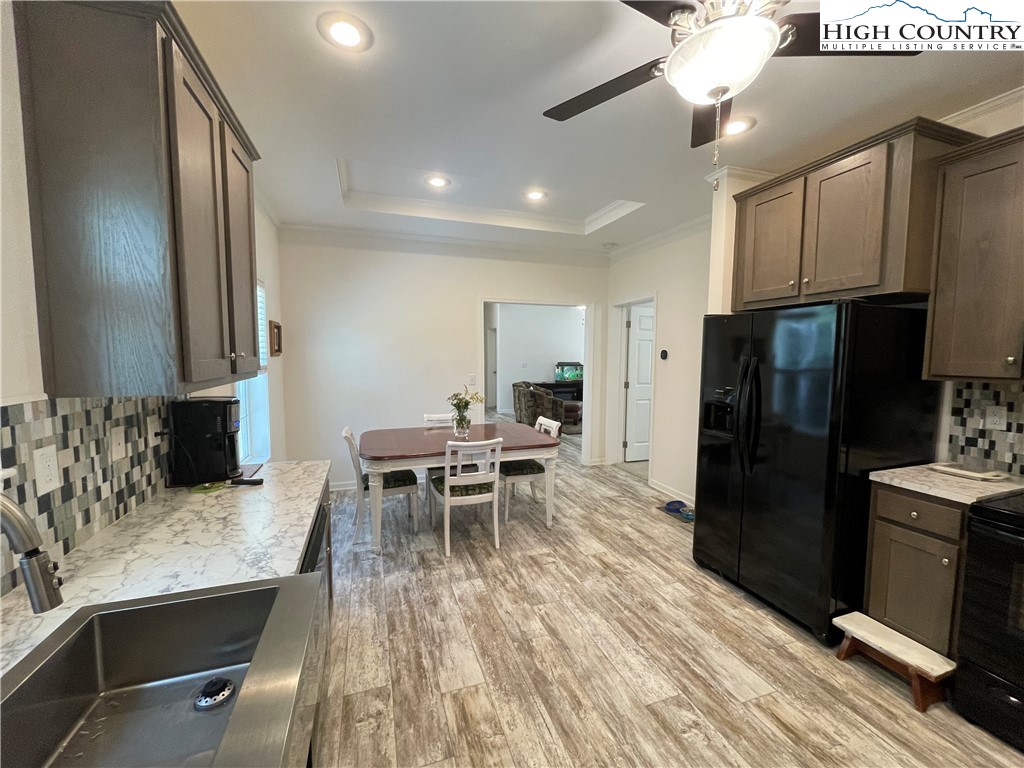227 Meadow Pines Trail Boone, NC 28607 - Photo 24 of 34 a kitchen with granite countertop kitchen island stainless steel appliances a sink stove and refrigerator