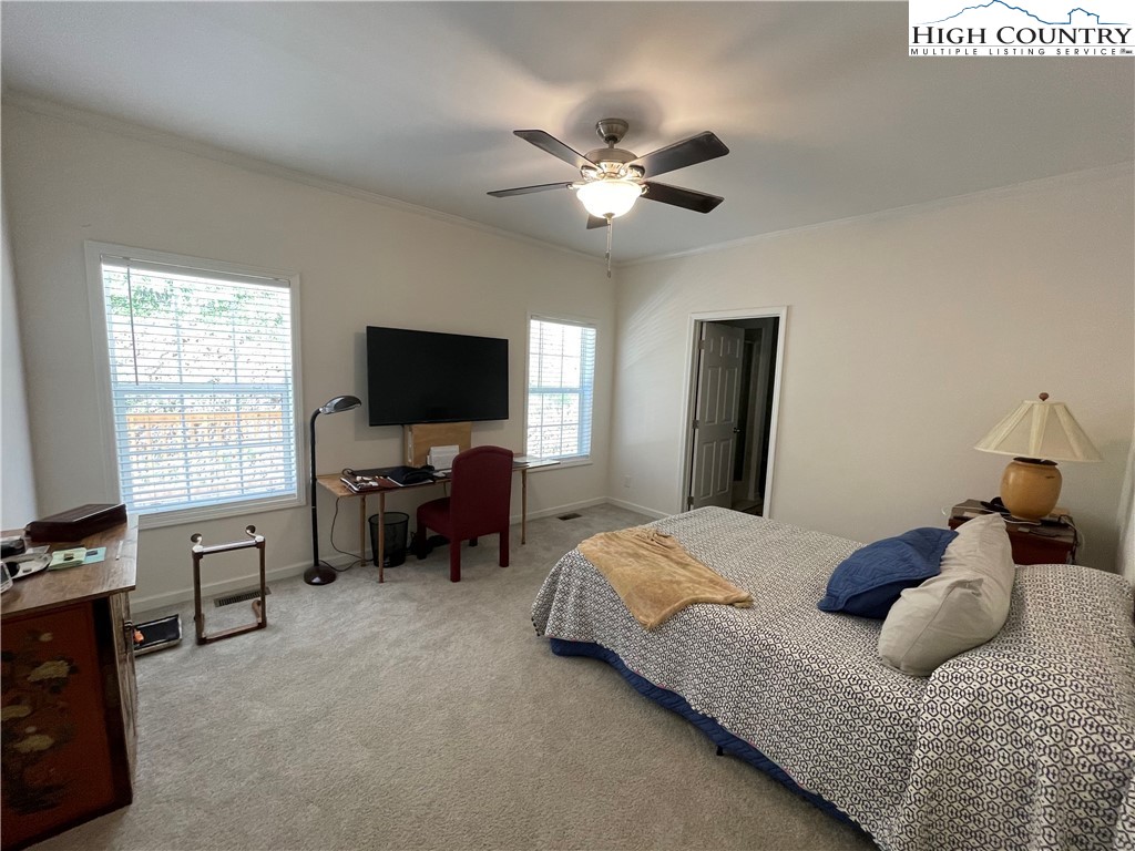 227 Meadow Pines Trail Boone, NC 28607 - Photo 26 of 34 a bedroom with a bed and a flat tv screen on dresser