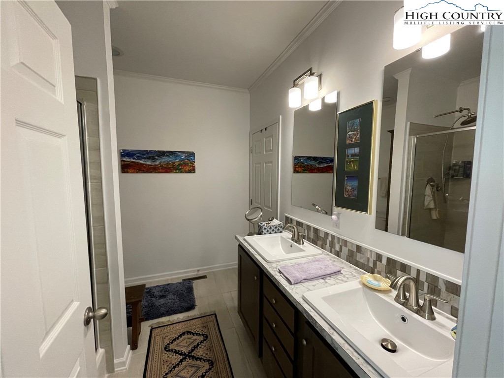 227 Meadow Pines Trail Boone, NC 28607 - Photo 28 of 34 a bathroom with a sink vanity and mirror