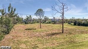 4695 Gulf Shore Road St. James City, FL 33956 - Photo 3 of 13 a view of a yard with a tree