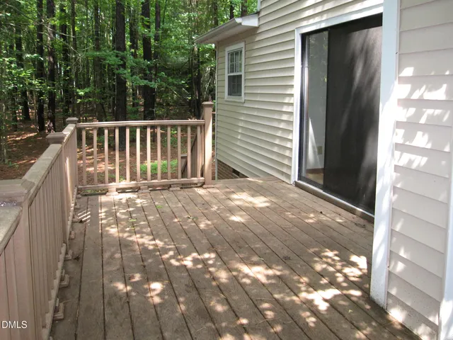 a view of backyard with deck and a garden