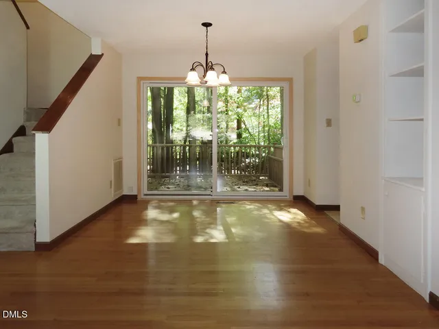 a view of an empty room with floor to ceiling windows
