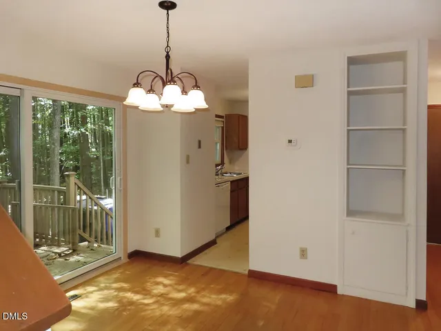 a view of a chandelier fan and wooden floor in a room