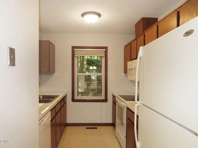 a kitchen with a refrigerator and a stove