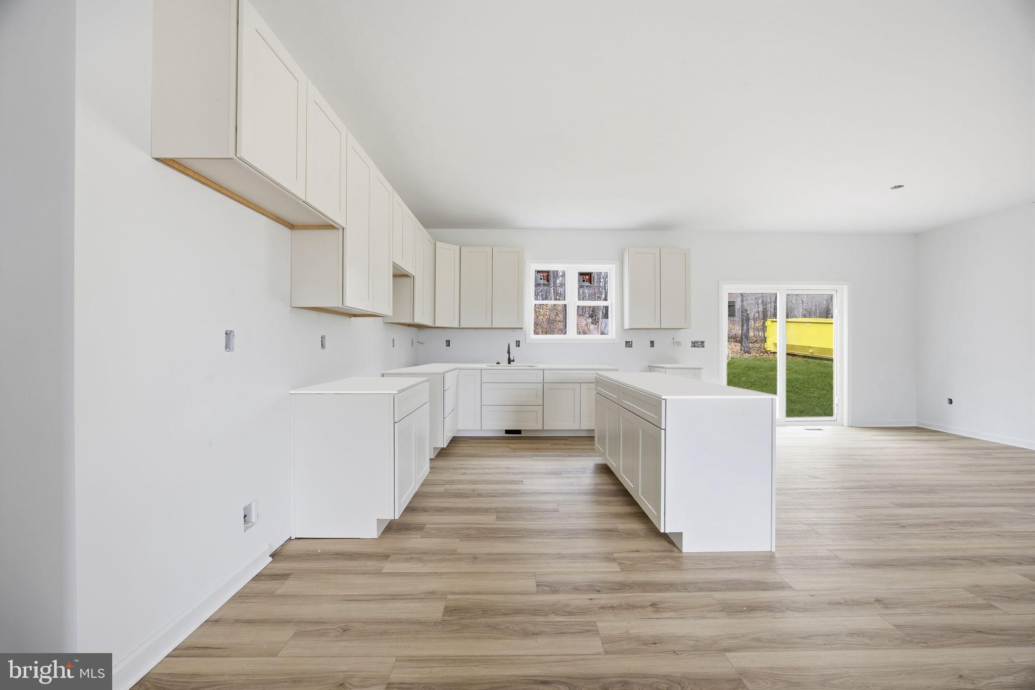 629 Providence Church Road Hedgesville, WV 25427 - Photo 14 of 54 a large white kitchen with wooden floors and white walls