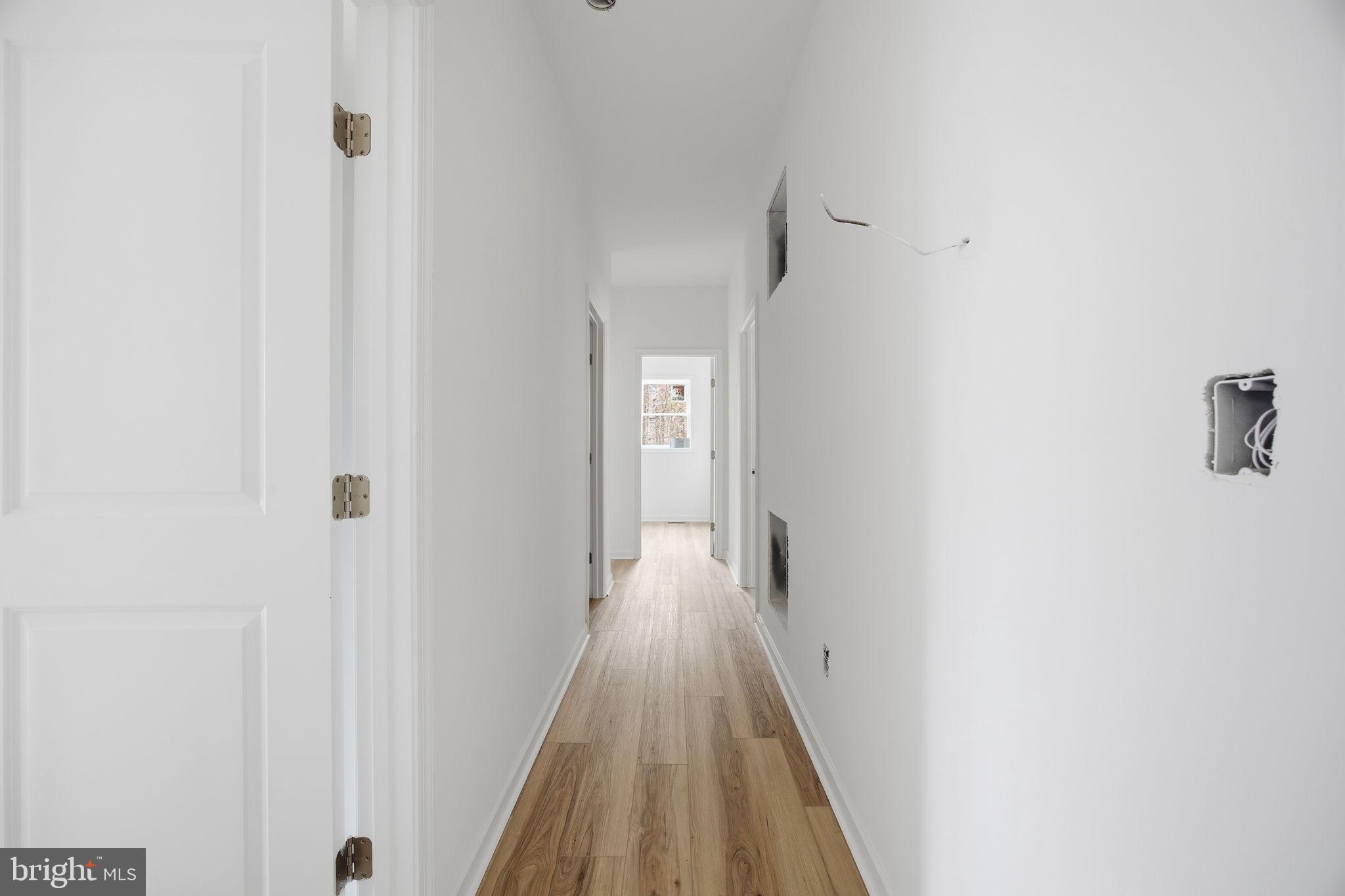 629 Providence Church Road Hedgesville, WV 25427 - Photo 30 of 54 a view of a hallway with wooden floor and a bathroom