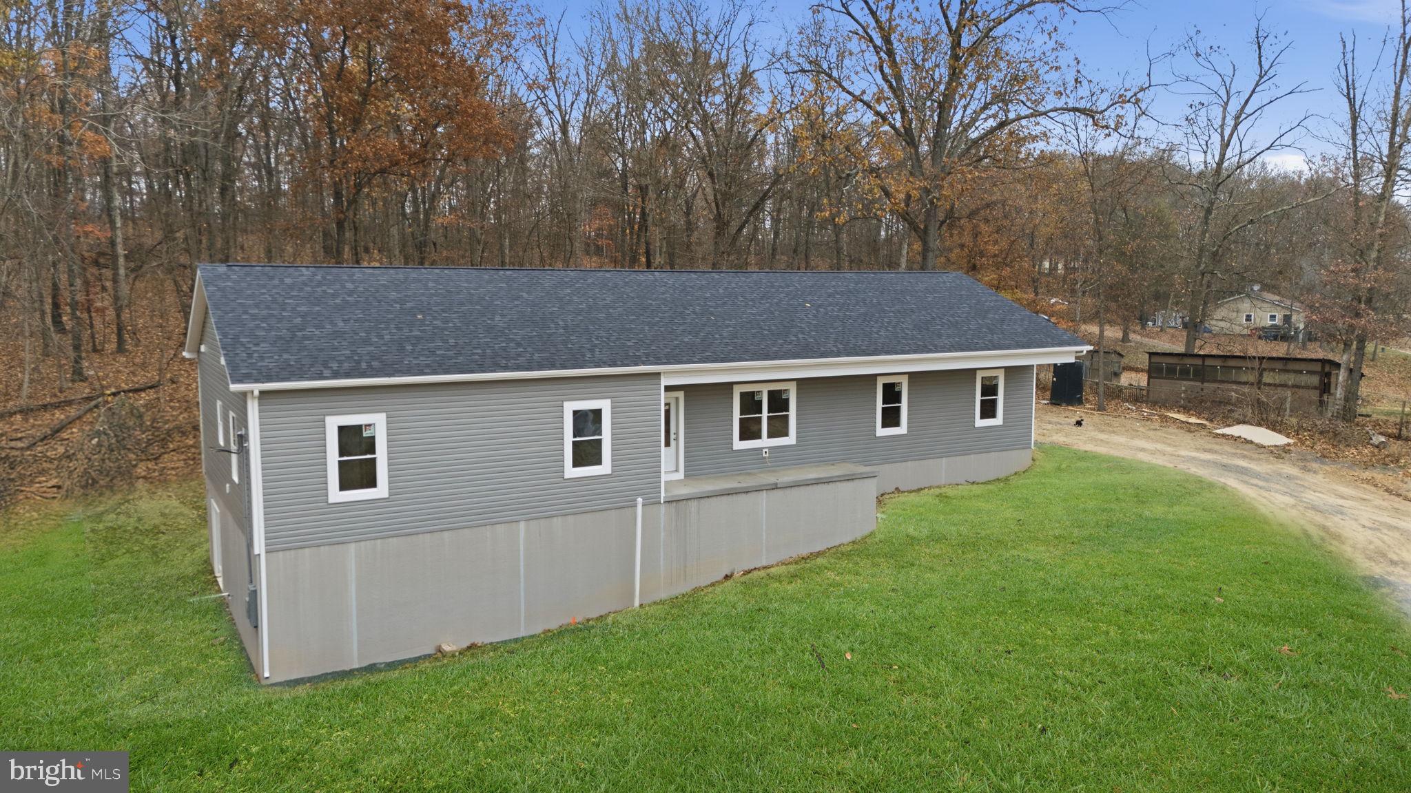 629 Providence Church Road Hedgesville, WV 25427 - Photo 3 of 54 a house that has tree in front of it