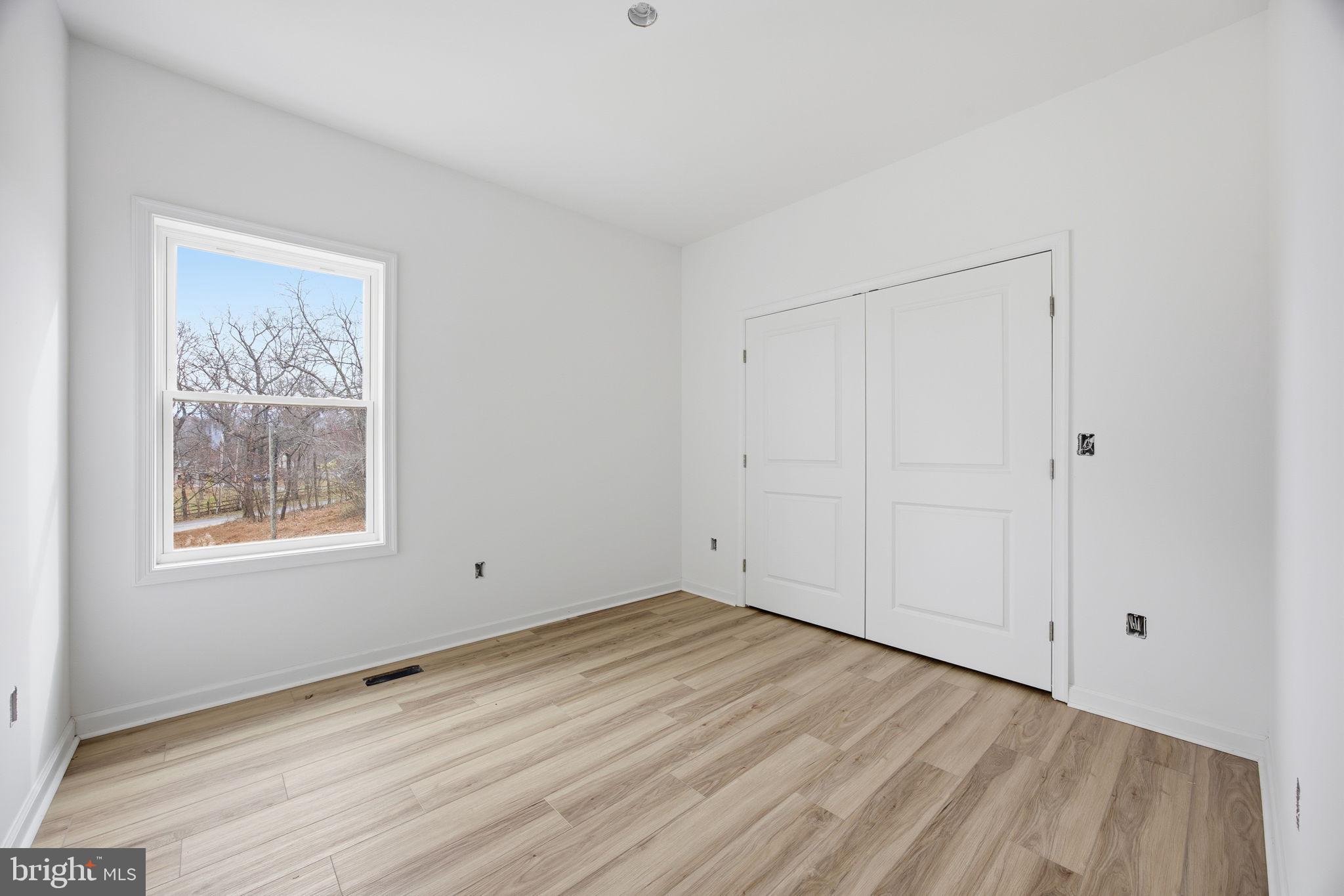 629 Providence Church Road Hedgesville, WV 25427 - Photo 32 of 54 a view of an empty room with wooden floor and a window