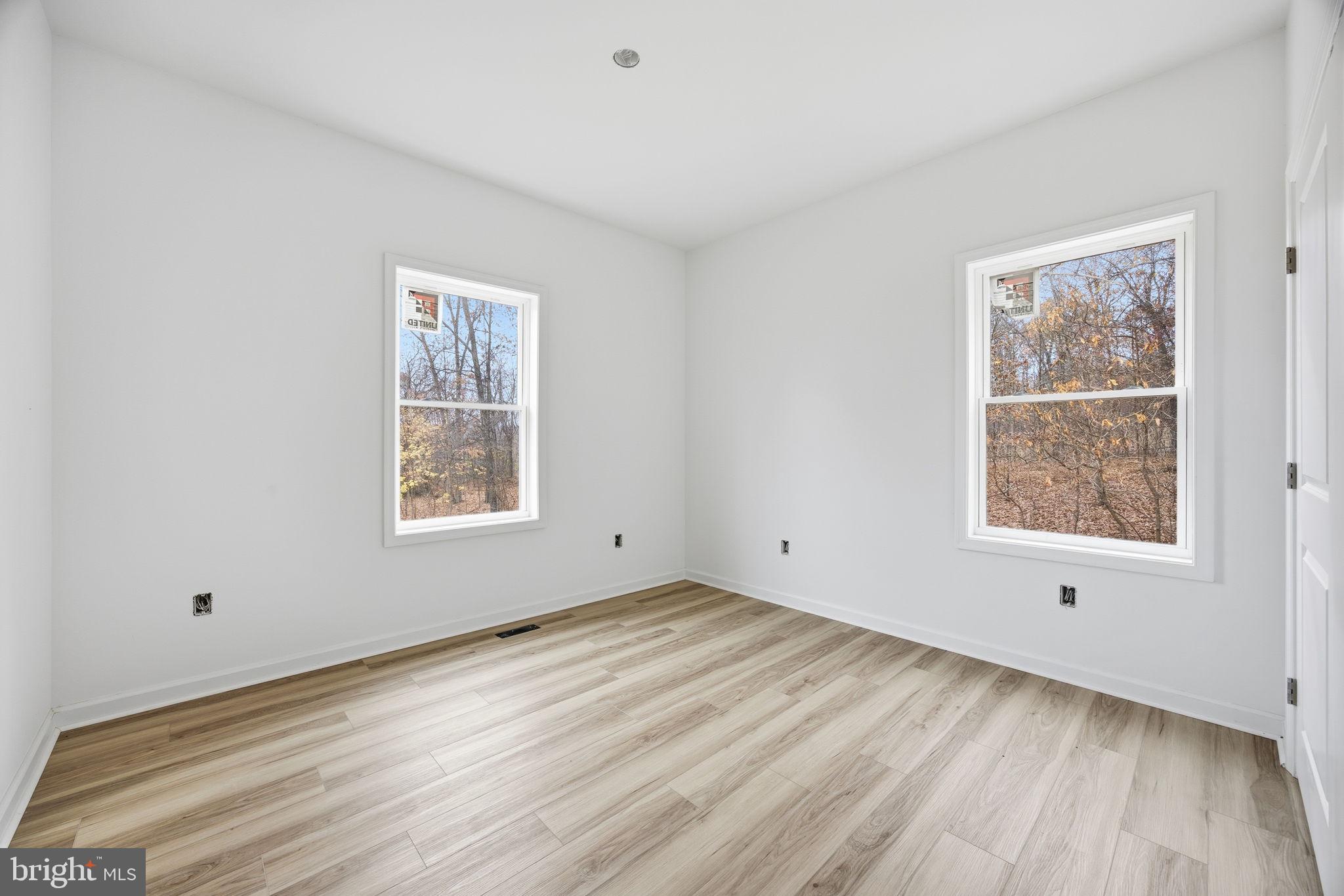629 Providence Church Road Hedgesville, WV 25427 - Photo 36 of 54 an empty room with wooden floor and windows