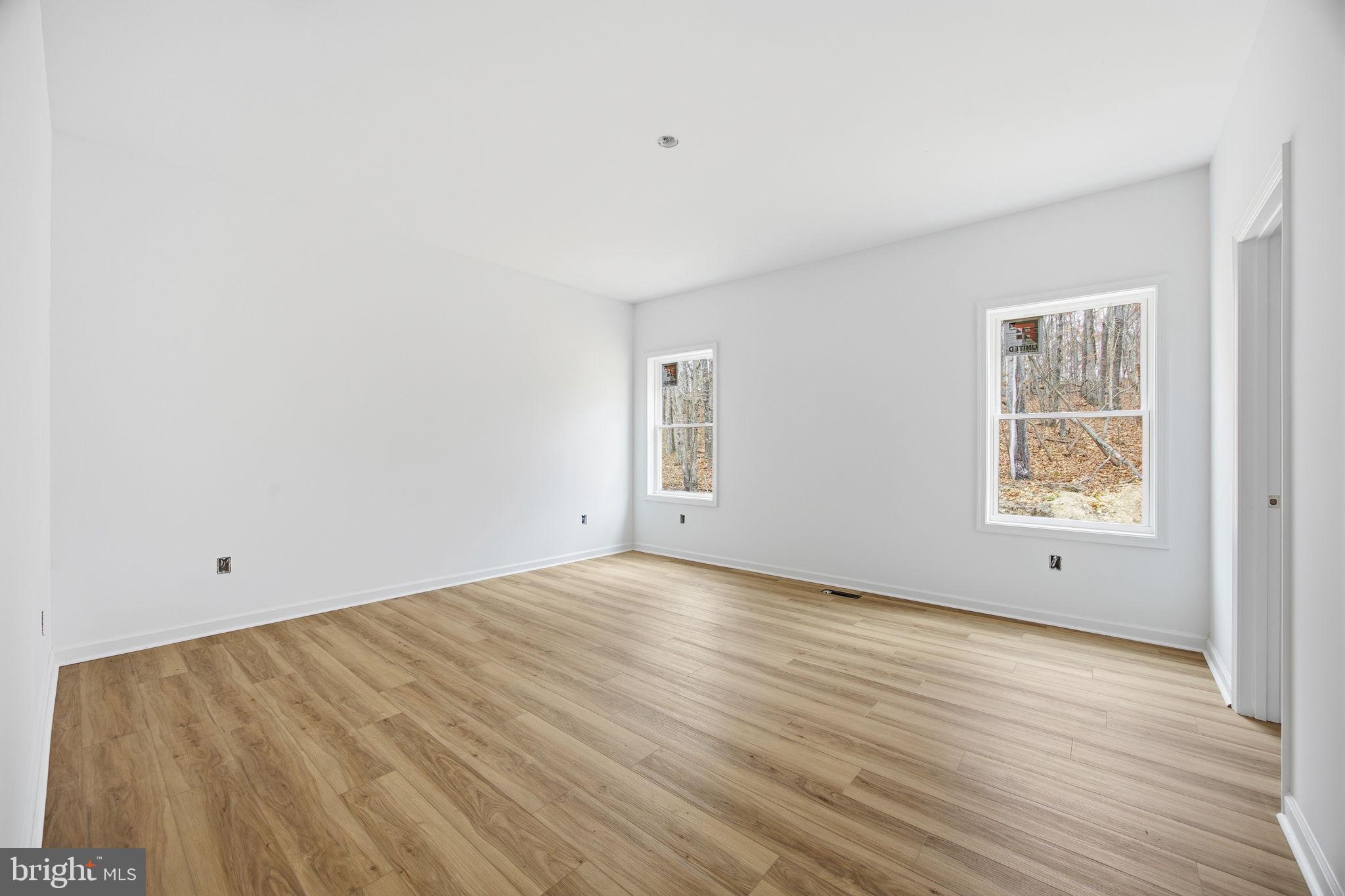 629 Providence Church Road Hedgesville, WV 25427 - Photo 40 of 54 an empty room with wooden floor and windows