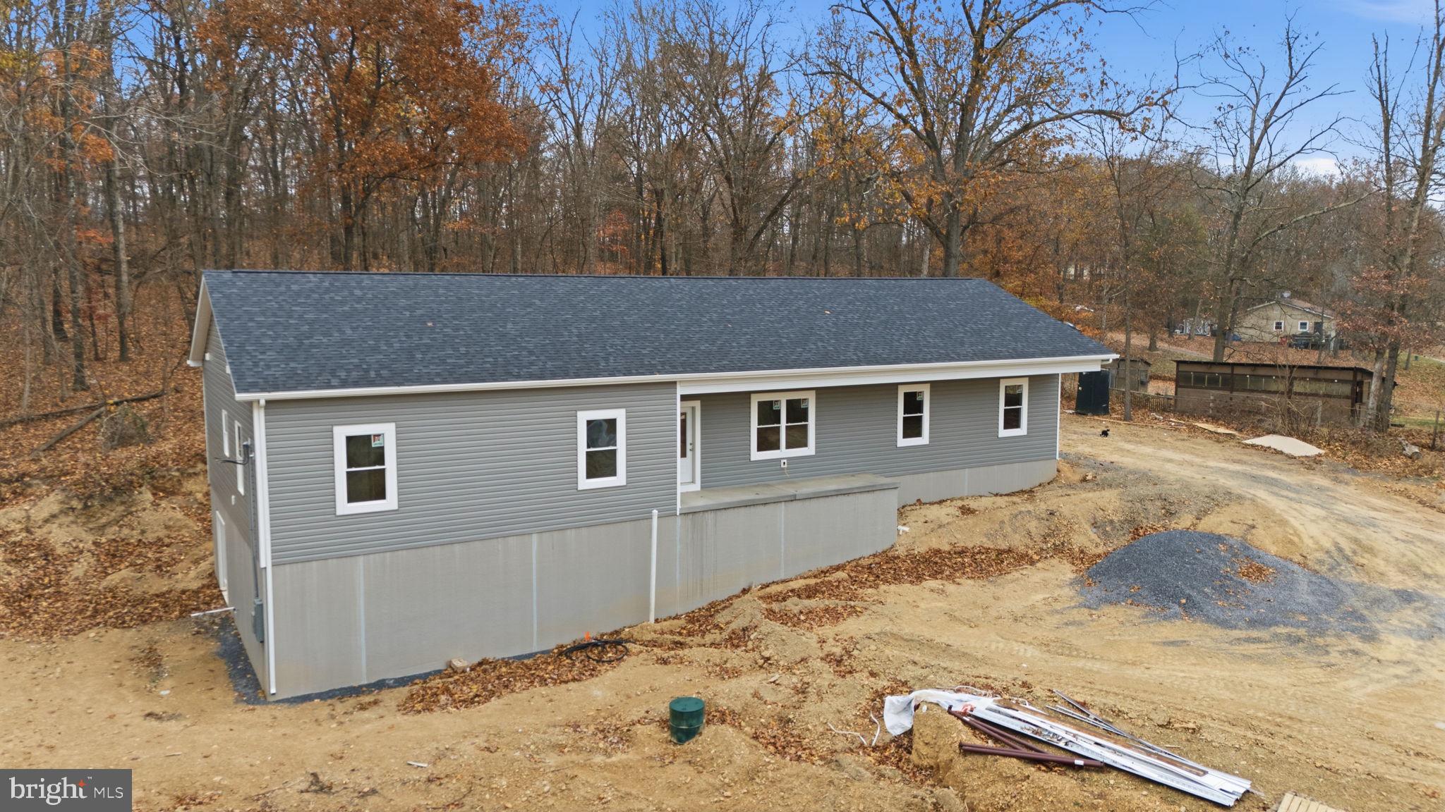 629 Providence Church Road Hedgesville, WV 25427 - Photo 10 of 54 a house with trees in the background