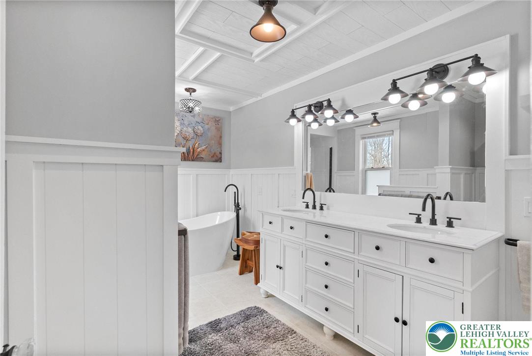 4303 Newburg Road Bethlehem, PA 18020 - Photo 33 of 63 a bathroom with a double vanity sink toilet and mirror