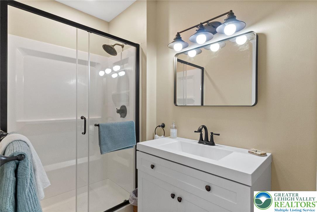 4303 Newburg Road Bethlehem, PA 18020 - Photo 40 of 63 a bathroom with a sink a mirror a vanity and shower