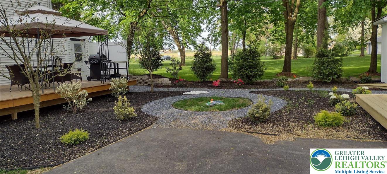 4303 Newburg Road Bethlehem, PA 18020 - Photo 48 of 63 a view of a patio with table and chairs under an umbrella