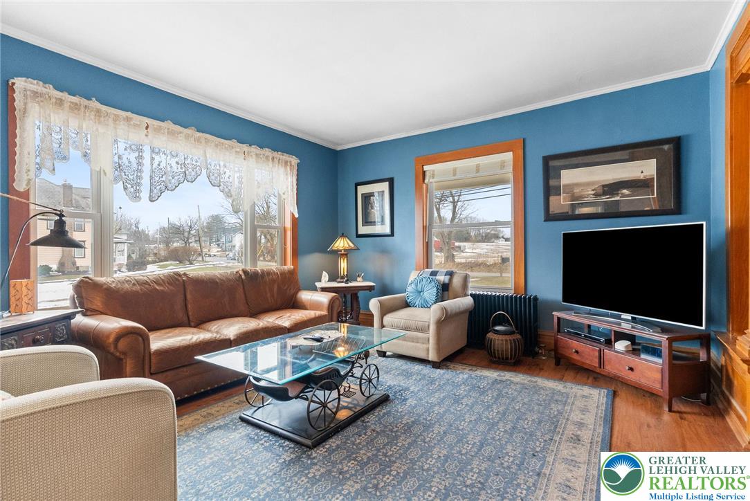 4303 Newburg Road Bethlehem, PA 18020 - Photo 7 of 63 a living room with furniture a large window and a flat screen tv
