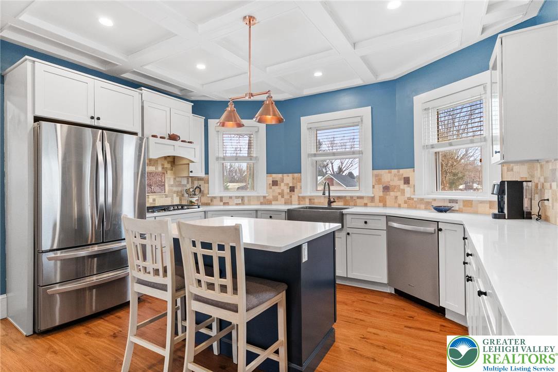 4303 Newburg Road Bethlehem, PA 18020 - Photo 10 of 63 a kitchen with a center island wooden floor and stainless steel appliances