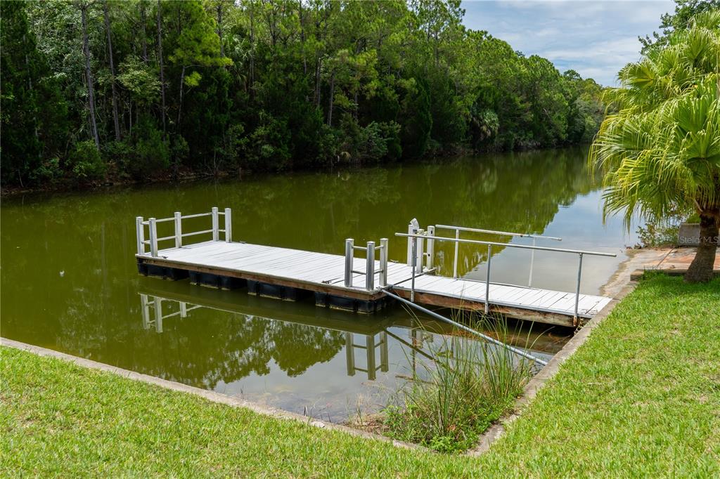 4050 Jew Fish Drive Hernando Beach, FL 34607 - Photo 13 of 16 a view of a lake with a wooden deck