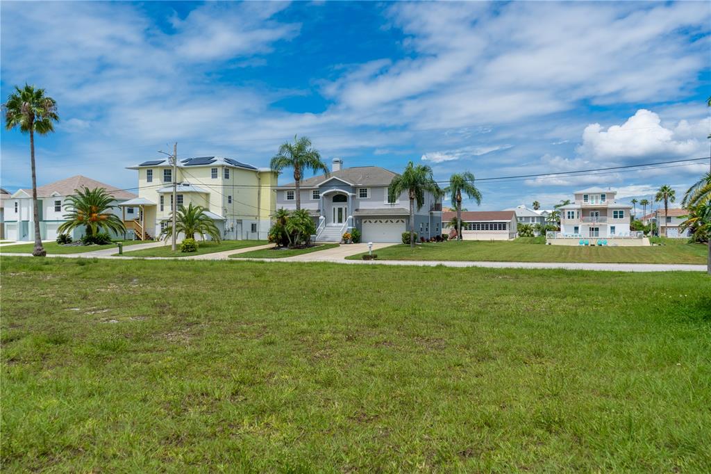4050 Jew Fish Drive Hernando Beach, FL 34607 - Photo 10 of 16 a view of a building with a big yard and large trees