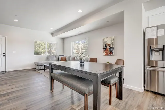 a view of a kitchen area with furniture and wooden floor