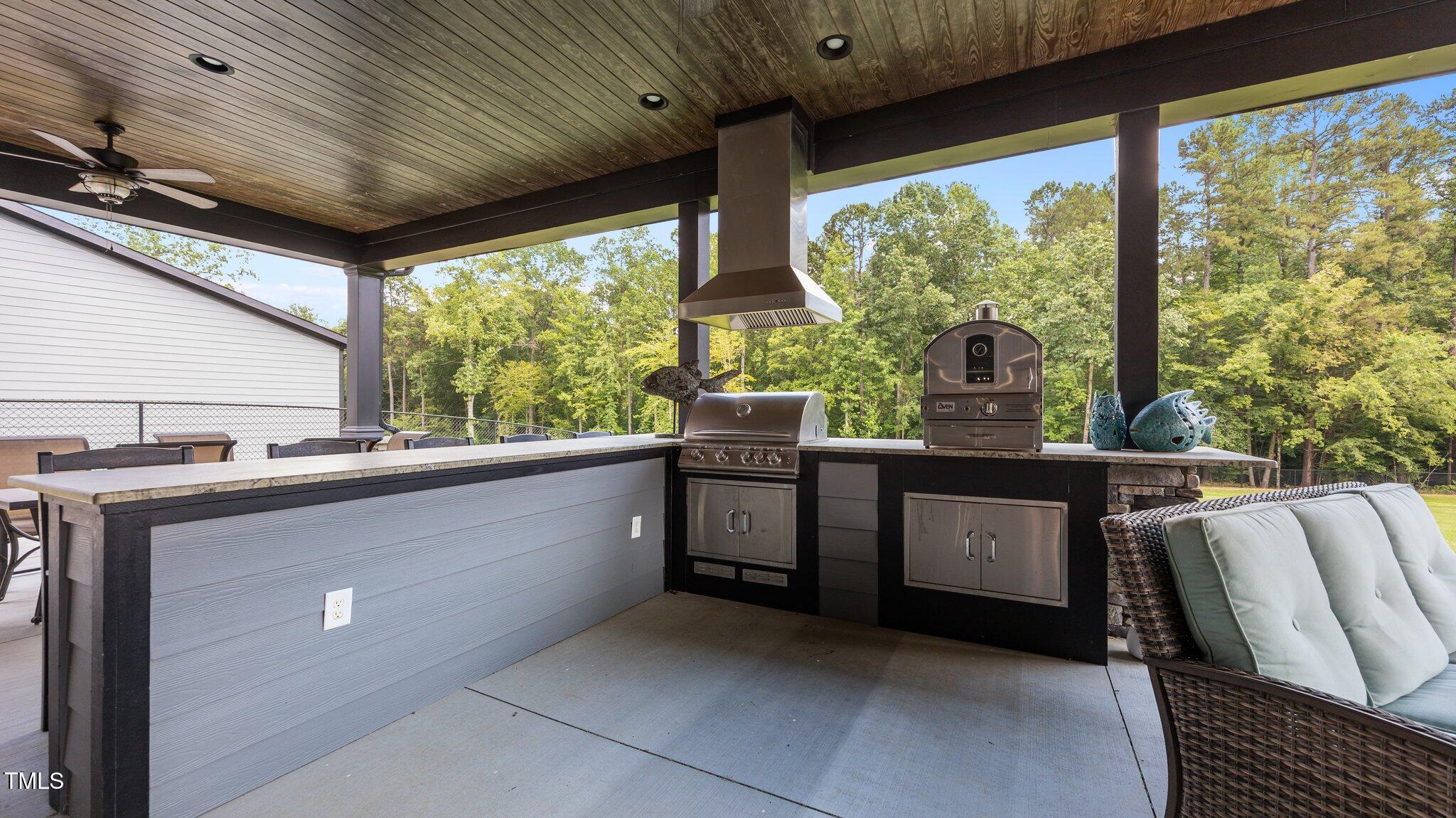 4152 Boyd Wright Road Burlington, NC 27215 - Photo 42 of 65 Blaze outdoor grill. Pizza oven. Leathered granite tops. Oversized bar with seating.
