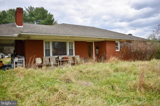 a backyard of a house with table and chairs