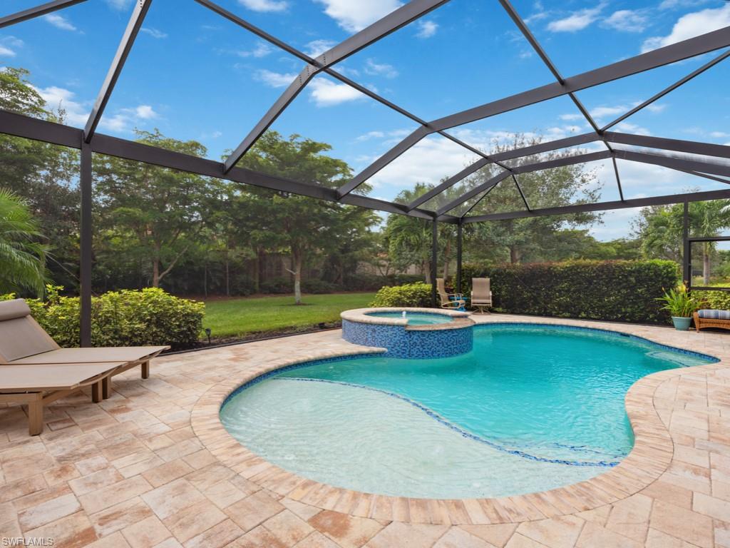 10191 Coconut Road Estero, FL 34135 - Photo 13 of 14 a view of a swimming pool with a patio