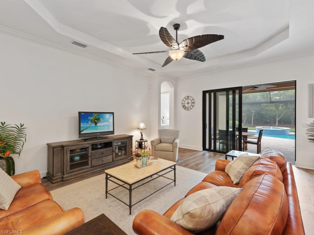 10191 Coconut Road Estero, FL 34135 - Photo 2 of 14 a living room with furniture a flat screen tv and a large window