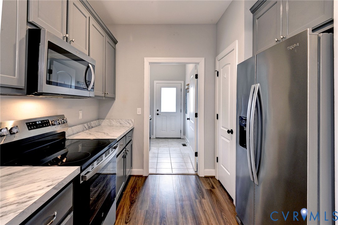 8904 Rock Cedar Road New Kent, VA 23124 - Photo 11 of 37 a kitchen with stainless steel appliances a stove microwave and a refrigerator