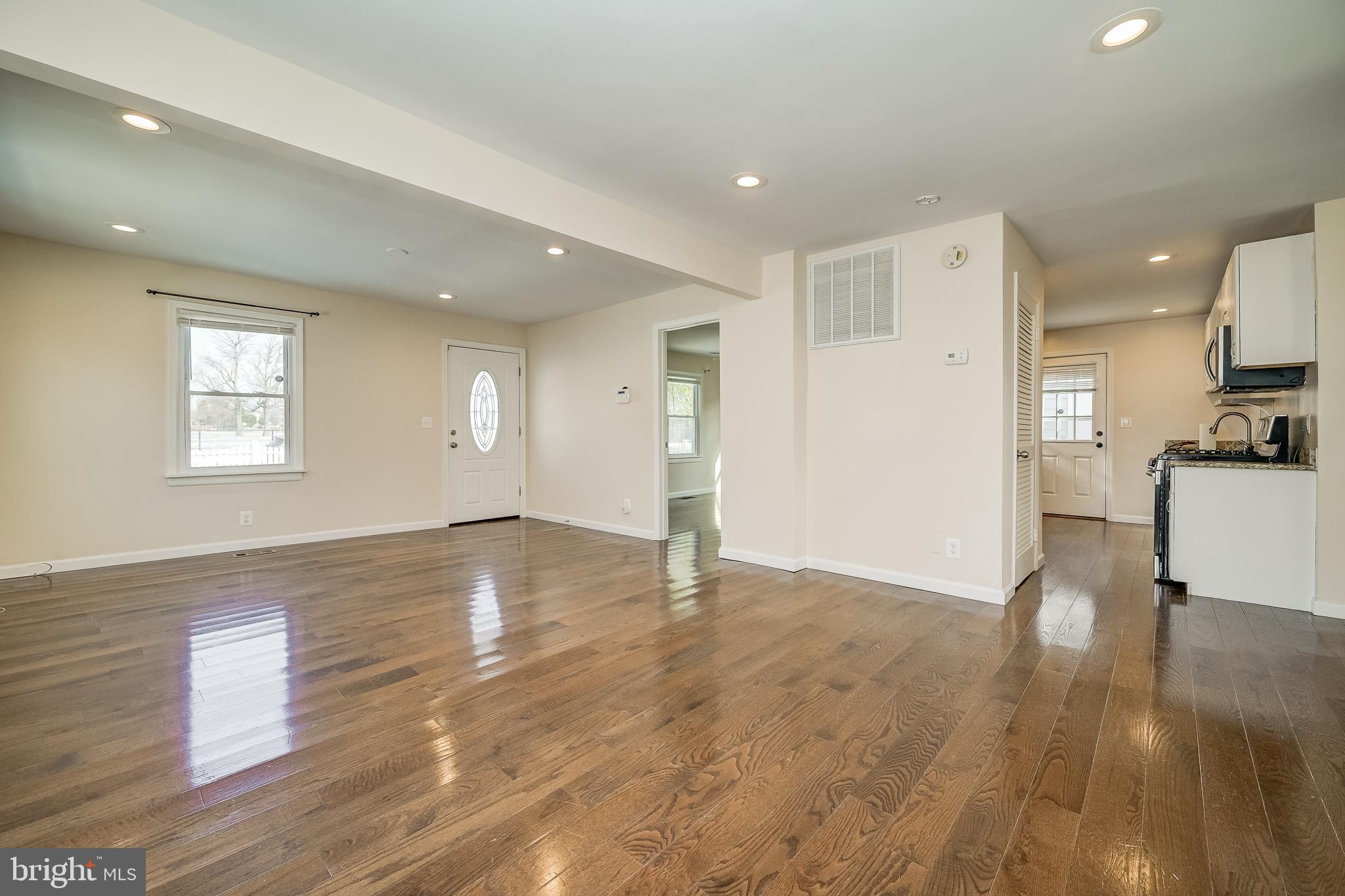 816 Maple Avenue Laurel, MD 20707 - Photo 12 of 45 a view of empty room with wooden floor and windows