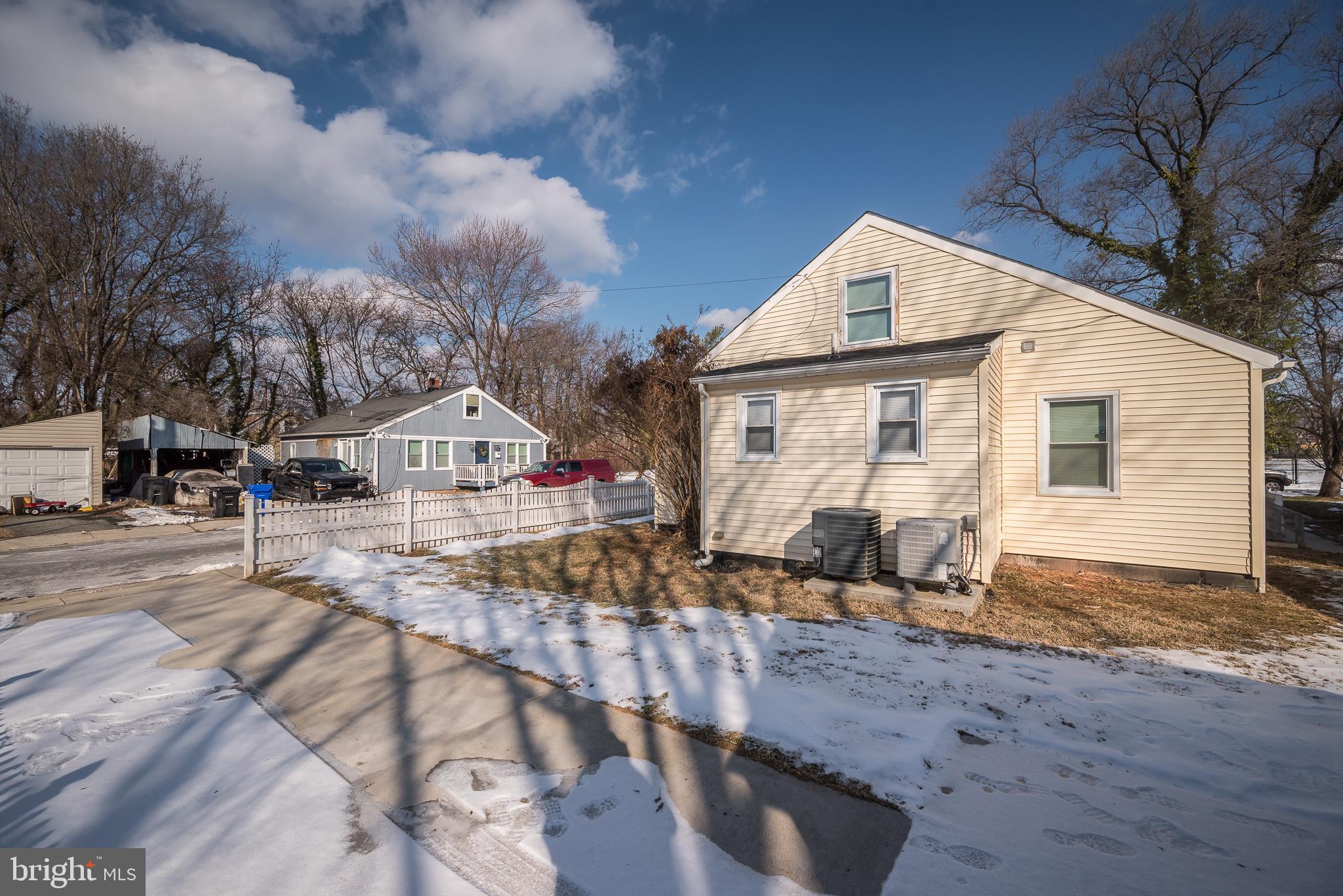 816 Maple Avenue Laurel, MD 20707 - Photo 45 of 45 a view of a white house with a yard covered in snow