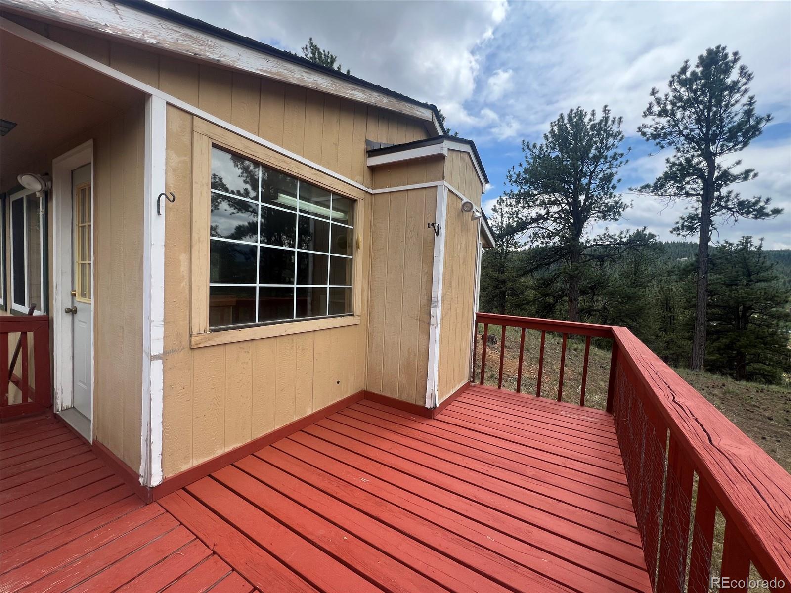 95 Appleby Street Bailey, CO 80421 - Photo 16 of 36 a balcony view with a wooden floor