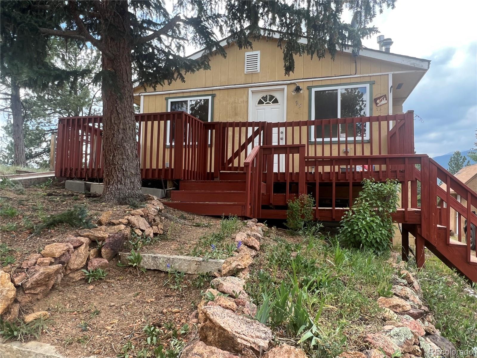 95 Appleby Street Bailey, CO 80421 - Photo 2 of 36 a view of a house with a yard and wooden fence