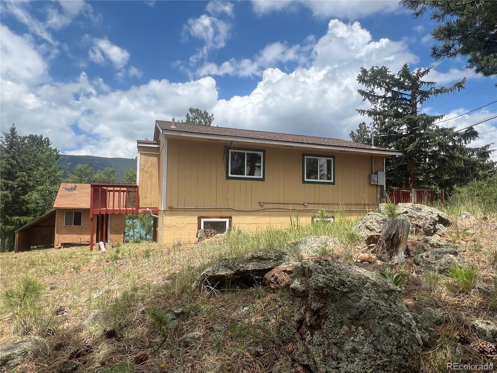 95 Appleby Street Bailey, CO 80421 - Photo 23 of 36 a backyard of a house with lots of green space