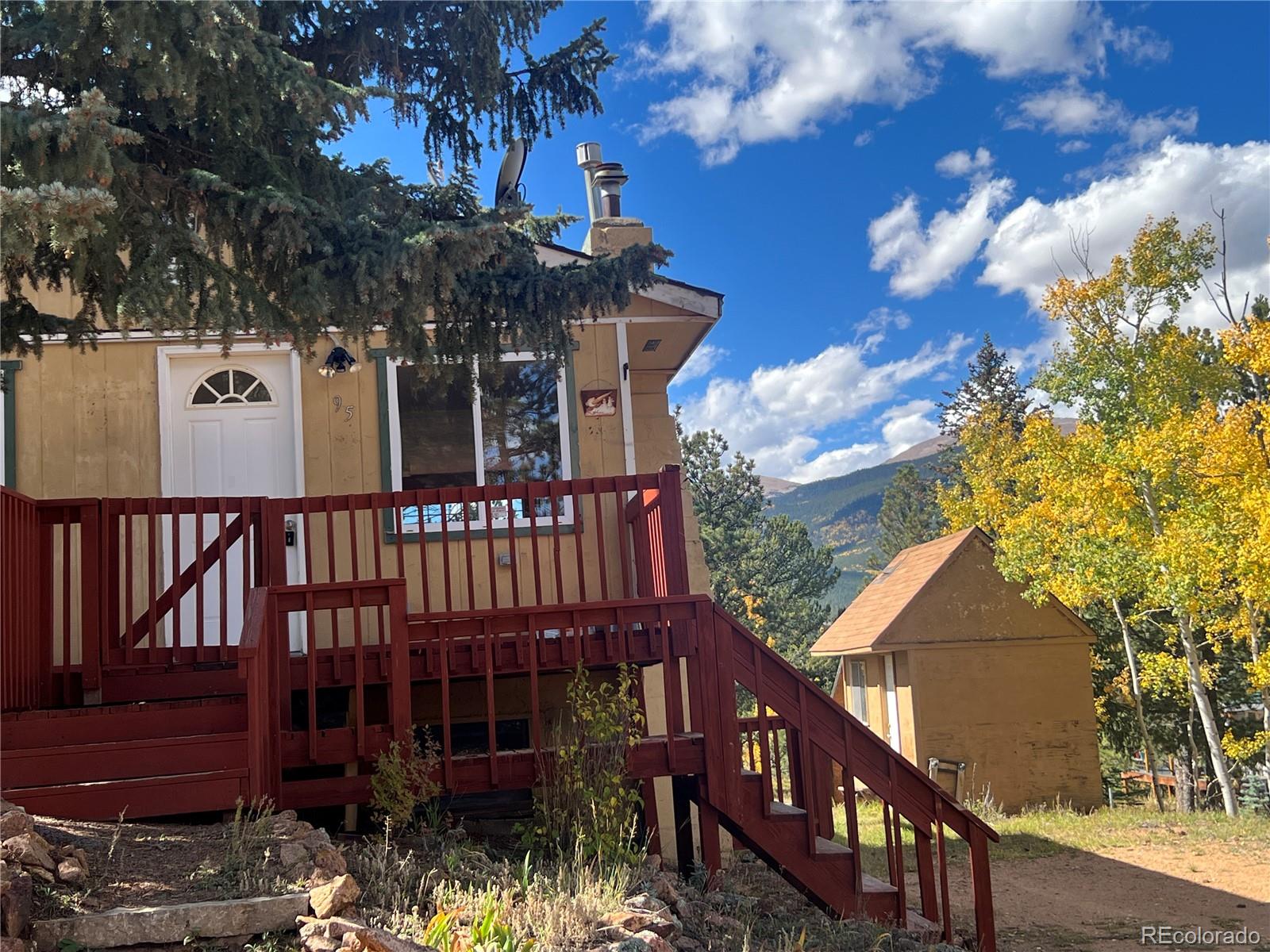 95 Appleby Street Bailey, CO 80421 - Photo 36 of 36 a view of a house with large tree and wooden fence